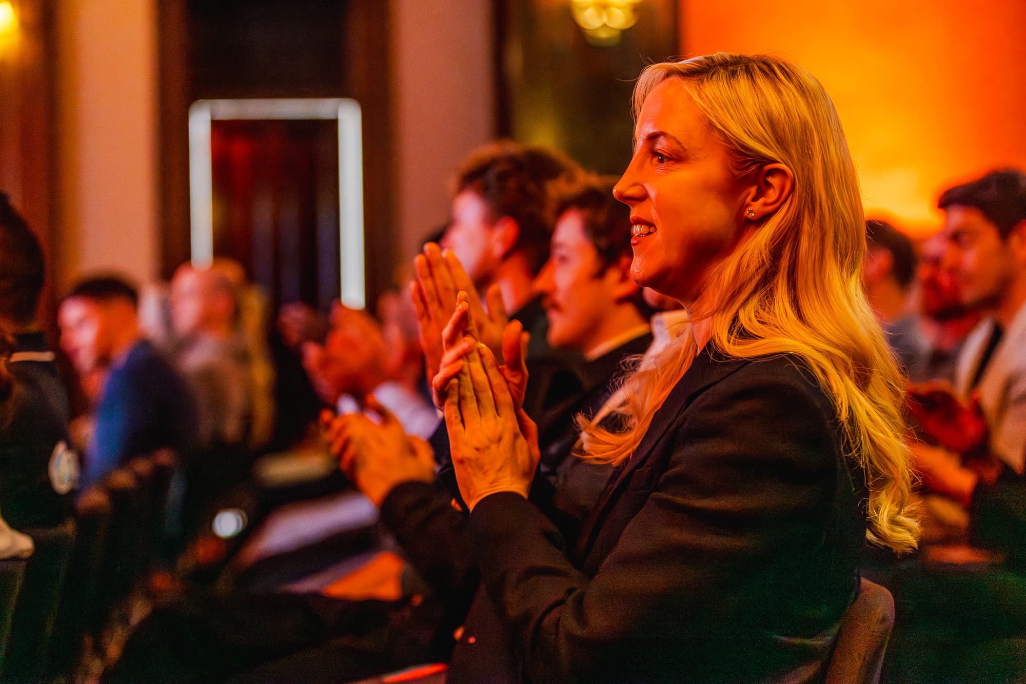 Photo of people clapping at an event