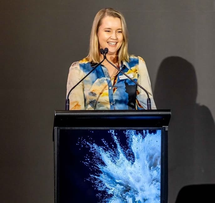 Head of Startup Development Elle Phillips speaking at a lectern.