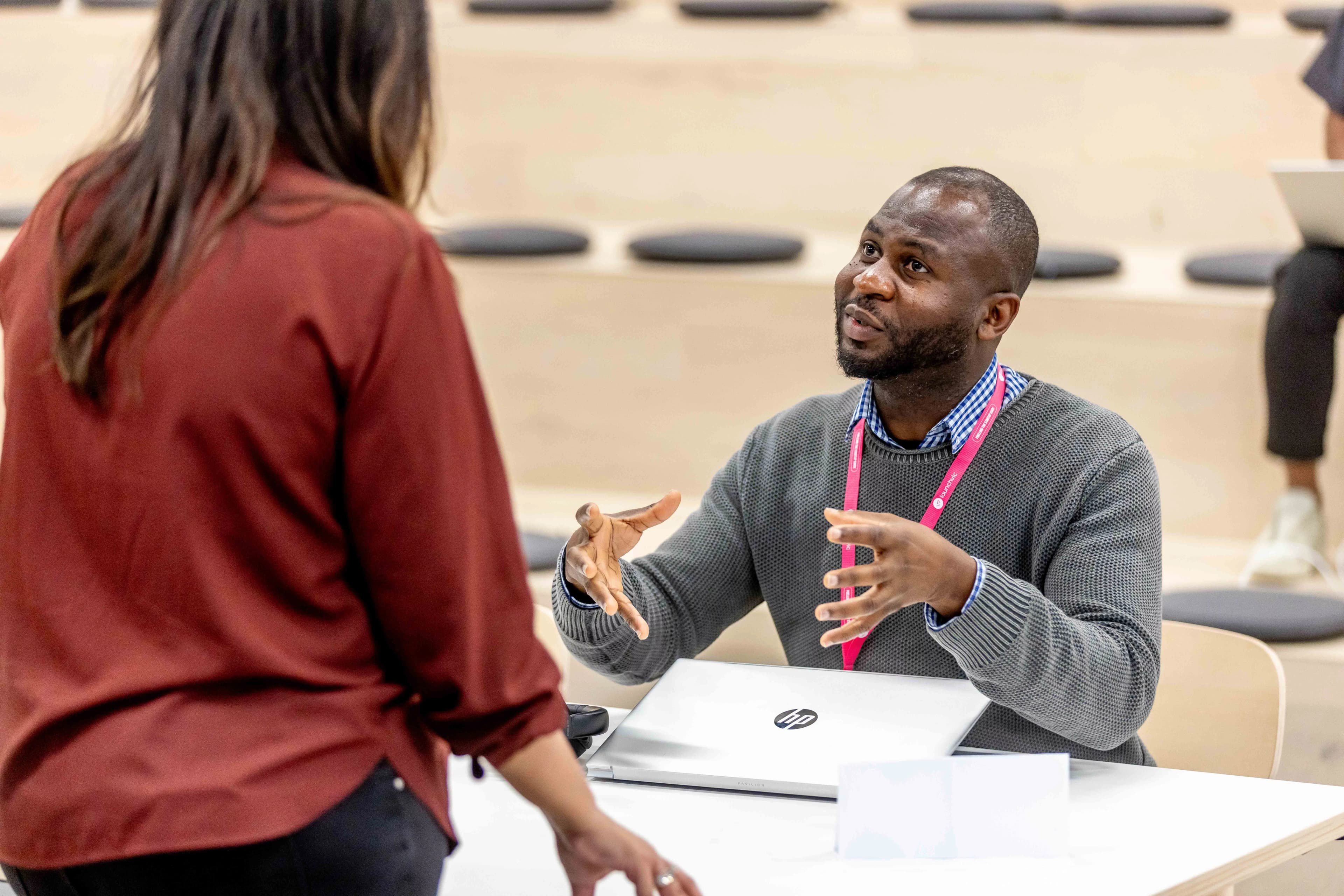 Emmanuel Adebayo from Meatshare speaking with another person at an event.